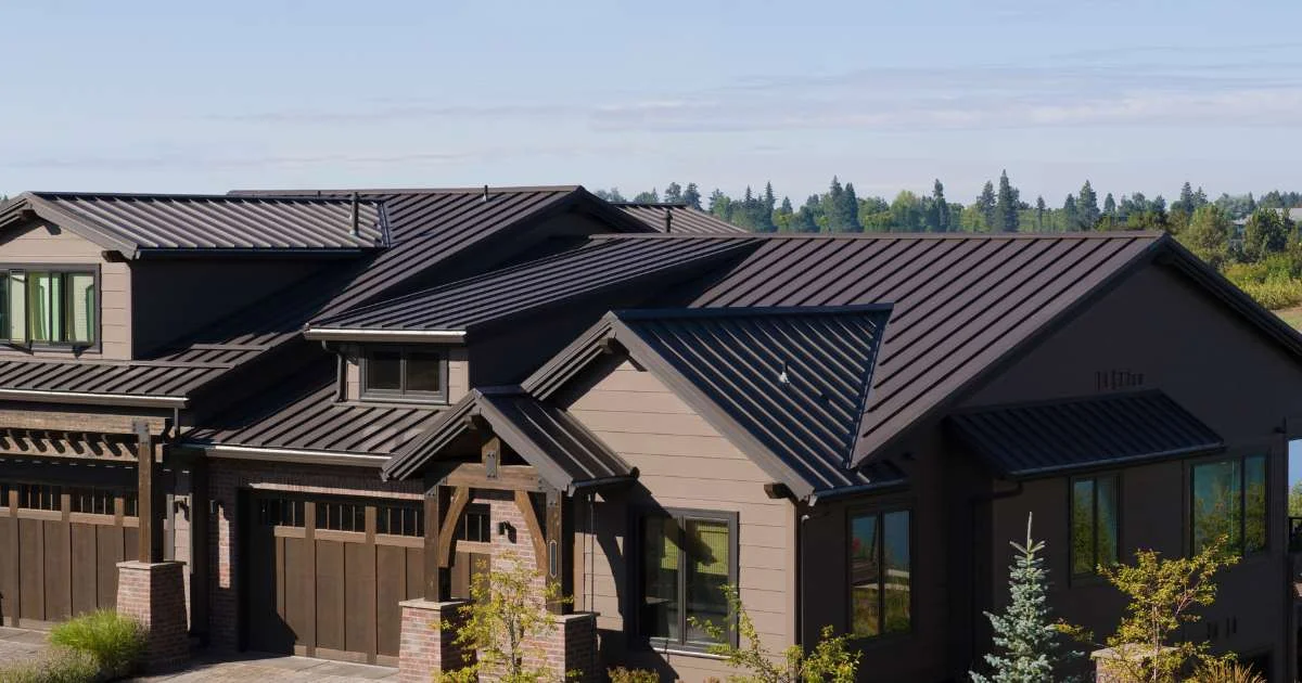 A modern house with a sleek brown metal roof, showcasing a durable and stylish roofing solution.